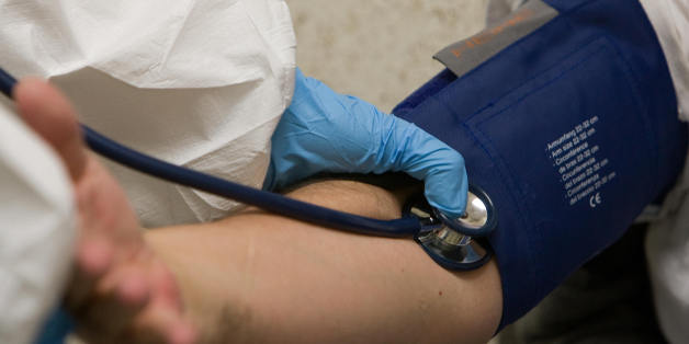 A nurse takes a patient's blood presure at the Navy Hospital in Mexico City on May 03, 2009 where Mexicans go to check up the flu symptoms. The influenza A (H1N1) (swine flu) virus epidemic in Mexico appears to be 'in a stabilization phase,' Health Minister Jose Angel Cordova said Saturday, but he warned the country was not out of the woods yet. AFP PHOTO/OMAR TORRES (Photo credit should read OMAR TORRES/AFP/Getty Images)