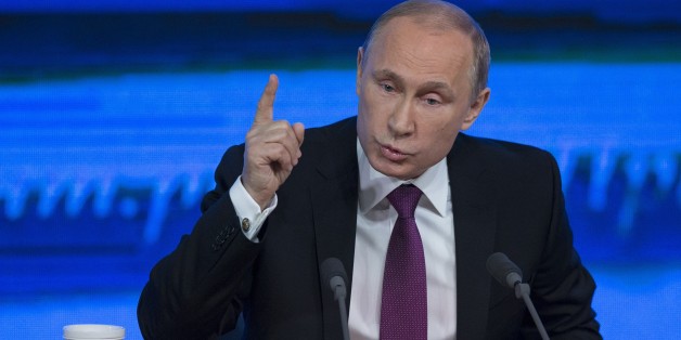 Russian President Vladimir Putin gestures during his annual news conference in Moscow, Russia, Thursday, Dec. 18, 2014. The Russian economy will rebound and the ruble will stabilize, Russian President Vladimir Putin said Thursday at his annual press conference, he also said Ukraine must remain one political entity, voicing hope that the crisis could be solved through peace talks. (AP Photo/Pavel Golovkin)