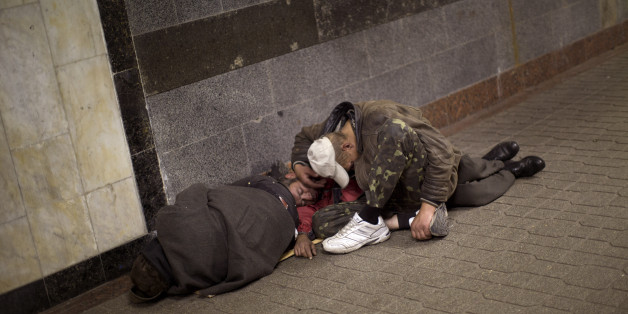 Homeless men sleep inside an underground shopping mall in central Kiev, Ukraine, Friday, Oct. 24, 2014. (AP Photo/Emilio Morenatti)