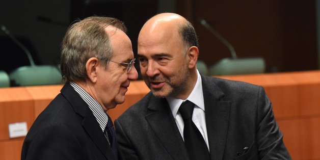 Italian Finance Minister Pier Carlo Padoan (L) and EU economic and financial affairs, taxation and customs commissioner Pierre Moscovici talk on December 8 2014 before the start of a Eurozone finance ministers meeting at EU headquarters in Brussels. AFP PHOTO / EMMANUEL DUNAND (Photo credit should read EMMANUEL DUNAND/AFP/Getty Images)