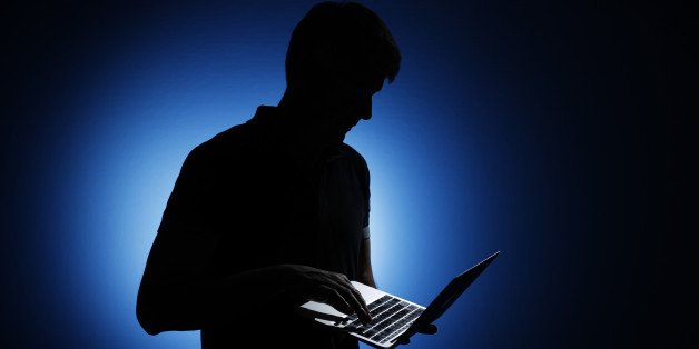 BERLIN, GERMANY - AUGUST 06: Silhouette of a man who is holding a laptop on August 06, 2014, in Berlin, Germany. (Photo by Thomas Trutschel/Photothek via Getty Images)***Local Caption***