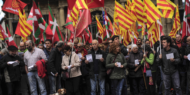 Pro-independence demonstrators of Catalonia and Basque Country raise their regional flags as they gather on a square to support an informal independence poll to celebrate in Catalonia, in Pamplona northern Spain, Sunday, Nov. 9, 2014. The pro-independence regional government of Catalonia stages a symbolic poll on secession in a show of determination and defiance after the Constitutional Court suspended its plans to hold an official independence referendum following a legal challenge by the Spanish government. (AP Photo/Alvaro Barrientos)