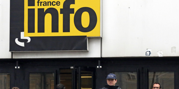 French police officers wearing bullet-proof jackets stand at the entrance of France Info radio station in Paris, Tuesday Nov. 19, 2013. French police are hunting for a gunman suspected in a shooting Monday at a Paris newspaper office that gravely wounded a photographer, as well as three other attacks around the nation's capital. The motive for the attacks, which prompted heightened security at media offices and the busy Champs-Elysees shopping avenue, is unclear. (AP Photo/Remy de la Mauviniere)