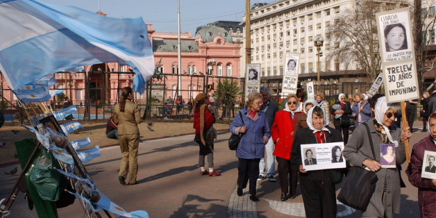 Members of human rights groups Mother of Plaza de Mayo, walk during their weekly protest putside Government Palace in Buenos Aires's Plaza de Mayo, to demand justice for their loved ones, Thursday, Aug. 21, 2003. Mothers who lost their children in Argentina's Dirty War claimed victory Thursday after Congress repealed two amnesty laws that shielded hundreds of military officers from prosecution for human rights abuses. (AP Photo/Eduardo Di Baia)