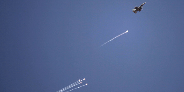 FILE - In this Wednesday, June 19, 2013 file photo, a fighter jet fires flares during Eager Lion multinational military maneuvers in Quweira, 186 miles south of Amman, Jordan. Jordan's prime minister says the country is hosting 900 U.S. military personnel to bolster its defence capabilities against potential threats from the Syrian civil war. The first Jordanian public official to speak publicly of the numbers of U.S. troops in the kingdom, Abdullah Ensour told reporters Saturday, June 22, 2013 that 200 of the personnel were experts training for how to handle a chemical attack. He said the remaining 700 are manning a Patriot missile defence system and F-16 fighter jets which Washington deployed this month in case the Syrian war worsens.(AP Photo/Maya Alleruzzo, File)