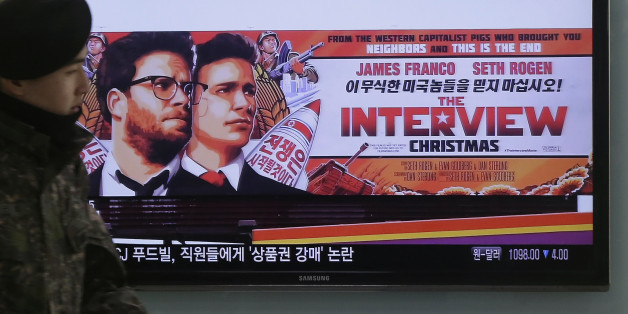 FILE - In this Dec. 22, 2014, file photo, a South Korean army soldier walks near a TV screen showing an advertisement of Sony Picture's "The Interview," at the Seoul Railway Station in Seoul, South Korea. It seems everyone has a theory about who really hacked Sony Pictures Entertainment Inc. Despite President Barack Obamaâs conclusion that North Korea was the culprit, the Internetâs newest game of whodunit continues. Top theories include disgruntled Sony insiders, hired hackers, other foreign governments or Internet hooligans. Even some experts are undecided, with questions about why the communist state would steal and leak gigabytes of data, email threats to some Sony employees and their families then threaten moviegoers who planned to watch âThe Interviewâ on Christmas. (AP Photo/Ahn Young-joon, File)