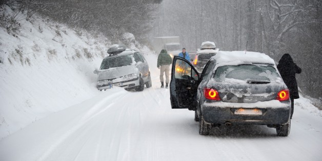 A car is stuck in the snow on December 27, 2014 on the road to Les Saisies ski resort in Savoie, central-eastern France. AFP PHOTO / JEAN-PIERRE CLATOT (Photo credit should read JEAN-PIERRE CLATOT/AFP/Getty Images)