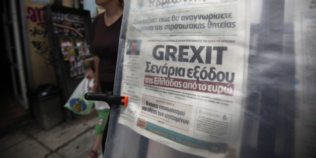 A pedestrian passes a 'Grexit' headline on a newspaper displayed at a street kiosk in Athens, Greece, on Thursday, May 24, 2012. European leaders tied their next steps on the financial crisis to the outcome of a bitterly contested election in Greece that may determine whether the 17-nation euro currency splinters. Photographer: Kostas Tsironis/Bloomberg via Getty Images