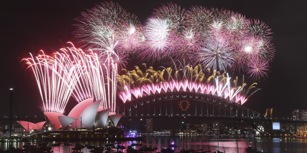 Fireworks explode over the Opera House and the Harbour Bridge during New Years Eve celebrations in Sydney, Australia, Thursday, Jan. 1, 2015. Thousands of people crammed into Lady Macquaries Chair look-out to see the new year in and watch the annual fireworks show. (AP Photo/Rob Griffith)