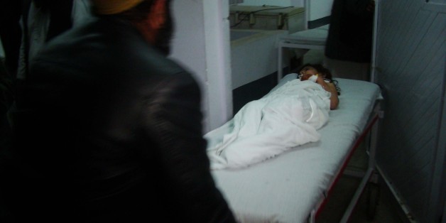 HELMAND, AFGHANISTAN - JANUARY 01: An Afghan kid, wounded by a missile attack on a wedding site in Helmand, is taken to Emergency Hospital in Lashkar Gah district of Helmand Province, Afghanistan on January 01, 2015. At least allegedly 20 people dead and 45 others wounded in this missile attack. (Photo by Abdul Hadi Roshan/Anadolu Agency/Getty Images)