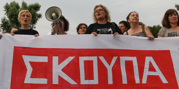 Laid-off former Finance Ministry cleaning staff, school teachers and school guards, shout slogans during a demo in the northern Greek port city of Thessaloniki, Tuesday, June 17, 2014. Hundreds of people took part in a solidarity protest, demanding that the government reinstate them in their jobs. Banner reads in Greek "broom". (AP Photo/Nikolas Giakoumidis)