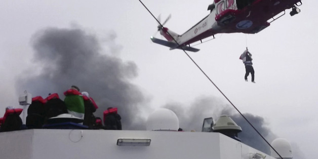 In this image taken from a Dec. 28, 2014 video and made available Wednesday, Dec. 31, 2014 a person is lifted from the deck of the Italian-flagged ferry Norman Atlantic by a rescue helicopter after it caught fire in the Adriatic Sea. More than 400 people were rescued from the ferry, most in daring, nighttime helicopter sorties that persisted despite high winds and seas, after a fire broke out before dawn Sunday on a car deck. Both Italian and Greek authorities have announced criminal investigations into the cause of the blaze. Italian authorities warned Tuesday that more bodies will likely be found when the blackened hulk of a Greek ferry is towed to Italy, as part of a criminal investigation into the fire that engulfed the ship at sea, killing at least 11 of the more than 400 people on board. (AP Photo/APTN)
