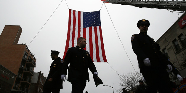 NEW YORK, NY - JANUARY 04: Police officers from around the country attend the funeral of slain New York City Police Officer Wenjian Liu, one of two officers murdered while sitting in their patrol car in an ambush in Brooklyn last month on January 4, 2015 in New York City. Thousands of fellow officers, family, friends and current FBI director James Comey attended the ceremony at the Brooklyn funeral home for the service. Liu's partner, officer Rafael Ramos, was buried last week in Queens. (Photo by Spencer Platt/Getty Images)