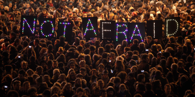 People gather in solidarity of the victims of a terror attack against a satirical newspaper, in Paris, Wednesday, Jan. 7, 2015. Masked gunmen shouting "Allahu akbar!" stormed the Paris offices of a satirical newspaper Wednesday, killing 12 people, including the paper's editor, before escaping in a getaway car. It was France's deadliest terror attack in living memory. (AP Photo/Thibault Camus)