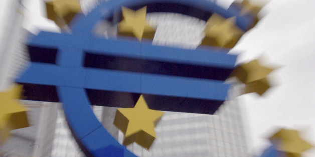 FILE- In this file photo dated Wednesday, Nov. 19, 2003, the Euro sign in front of the headquarters of the European Central Bank in Frankfurt, Germany. On Tuesday Dec. 2, 2014, the issue of looming deflation seems the main factor driving European policymakers when they meet later this week and forcing speculation that the ECB will switch on the printing press to help the economy by injecting new money into the economy. (AP Phto/Bernd Kammerer, FILE)