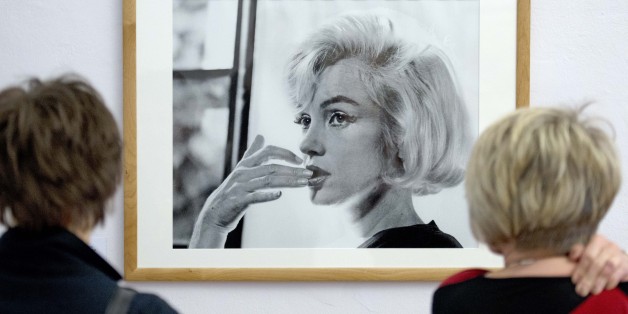 Visitors stand in front of a photo taken by Allan Grant in the exhibition âThe Last Sitting â Marilyn Monroeâ in the Apolda Avantgarde Arts' Centre (Kunsthaus) in Apolda, Germany, Saturday, April 5, 2014. The exhibition focuses on shots taken by New York photographer Bert Stern in 1962 six weeks before the actressâs death. The exhibition runs from April 5 to June 26, 2014 . (AP Photo/Jens Meyer)