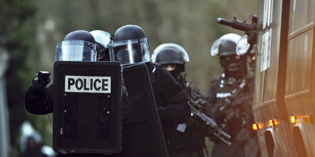 French police officers patrol in Longpont, north of Paris, France, Thursday, Jan. 8, 2015. Scattered gunfire and explosions shook France on Thursday as its frightened yet defiant citizens held a day of mourning for 12 people slain at a Paris newspaper. French police hunted down the two heavily armed brothers suspected in the massacre to make sure they don't strike again. (AP Photo/Thibault Camus)