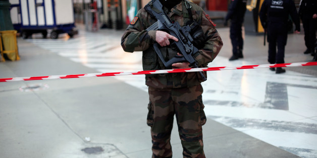A French soldier patrols at the Gare du Nord railway station, in Paris, France, Thursday, Jan. 8, 2015. Scattered gunfire and explosions shook France on Thursday as its frightened yet defiant citizens held a day of mourning for 12 people slain at a Paris newspaper. French police hunted down the two heavily armed brothers suspected in the massacre to make sure they don't strike again. (AP Photo/Thibault Camus)