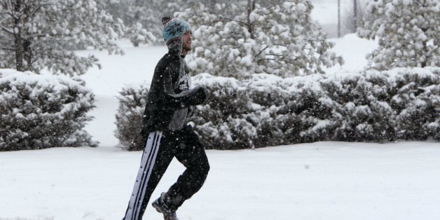 Christopher Joseph, a Rutgers University student, jogs along a road in South Brunswick, N.J., during a snow storm Friday, Feb. 22, 2008. Joseph said he is training for a marathon and didn't want to stop his routine for the snow. (AP Photo/Mike Derer)