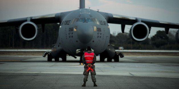 Airman 1st Class Damien Goodman marshals a C-17A Globemaster III before a flight Feb. 28, 2013, at Joint Base Charleston, S.C. Members of the 437th Aircraft Maintenance Squadron inspect, service, and maintain the C-17s to enable the aircraft to perform global airlift missions ranging from combat support operations and humanitarian relief to aeromedical evacuations. Goodman is a crew chief assigned to the 437th Aircraft Maintenance Squadron. (U.S. Air Force photo/ Senior Airman George Goslin)