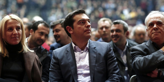 Alexis Tsipras, leader of the Syriza party, center, listens to a speaker during a pre-election party congress in Athens, Greece, on Saturday, Jan. 3, 2014. Greece's political parties embarked on a flash campaign for elections in less than three weeks that Prime Minister Antonis Samaras said will determine the fate of the countrys membership in the euro currency area. Photographer: Kostas Tsironis/Bloomberg via Getty Images