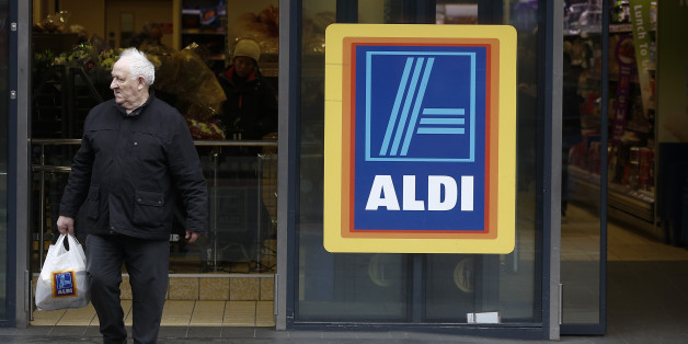 A customer exits an Aldi Stores Ltd. supermarket in the Kilburn district of London, U.K., on Monday, Dec. 22, 2014. German discounters Aldi and Lidl spent twice as much on British advertising as U.K. grocery leader Tesco Plc in the initial buildup to Christmas as they sought to build on market share gains at the seasonal peak. Photographer: Simon Dawson/Bloomberg via Getty Images