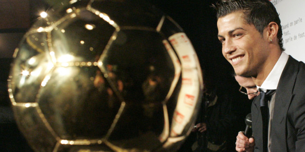 Portuguese international soccer star Cristiano Ronaldo watches his 'Ballon d'Or' (Golden Ball) award, during a photocall at the studios of a French television channel, following a live brodcast soccer show, Sunday, Dec. 7, 2008 in Paris. Ronaldo received the Ballon d'Or, the prize awarded to the Europe-based footballer of the year on Sunday. Ronaldo led Manchester United to an English Premier League and Champions League double last season, scoring an impressive 42 goals in all competitions along