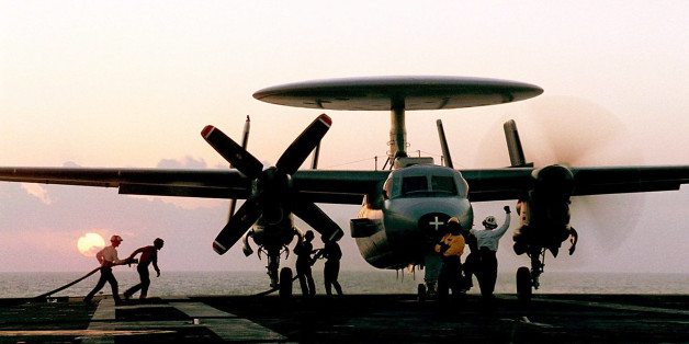 In this undated handout photo from the French Navy, technicians refuel a hawkeye plane on the flight deck of the French nuclear-powered aircraft carrier Charles de Gaulle in the Indian ocean. French military planes support U.S. jets with air missions focused on reconnaissance operations in Afghanistan.(AP Photo/ Marine Nationale, Patrick Fromentin)