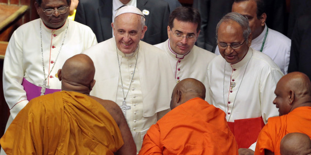 Pope Francis smiles as he speaks to Buddhist monks after an inter-religious meeting in Colombo, Sri Lanka, Tuesday, Jan. 13, 2015. Pope Francis brought calls for reconciliation and justice to Sri Lanka on Tuesday as he began a weeklong Asian tour, saying the island nation can't fully heal from a quarter-century of brutal civil war without pursuing the truth about abuses that were committed. (AP Photo/Eranga Jayawardena)