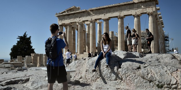 Tourists visit the Parthenon Temple at the Acropolis hill in Athens on October 12, 2014. Human rights lawyer Amal Alamuddin Clooney, wife of the Hollywood star George Clooney, will be visiting Athens next week to advise the Greek government in its battle to repatriate the ancient Parthenon sculptures that are presently on display in the British museum. The marbles were removed from the Acropolis in Athens by Lord Elgin, while Athens was under Ottoman control in the 19th century. She is expected to hold a series of meetings with government officials during her stay. AFP PHOTO/ LOUISA GOULIAMAKI (Photo credit should read LOUISA GOULIAMAKI/AFP/Getty Images)