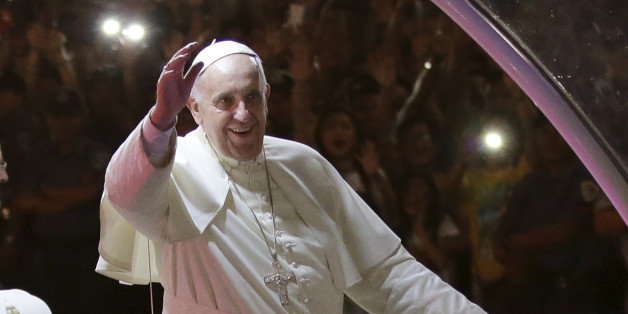 Pope Francis smiles as he waves to Filipinos during his motorcade upon his arrival in Manila, Philippines Thursday, Jan. 15, 2015. Ecstatic crowds greeted Francis as he arrived Thursday in the Philippines, Asia's most populous Catholic nation, for the first papal visit in 20 years. (AP Photo/Aaron Favila)