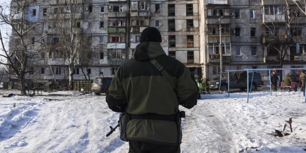 A pro-Russian rebel walks towards a building occupied by pro-Russian rebels and turned into firing position near the Donetsk airport in Donetsk, Eastern Ukraine, Thursday, Jan. 15, 2015. Russian-backed separatists announced Thursday they had captured the shattered remains of the Donetsk airport terminal in eastern Ukraine and plan to claw back more territory, further dashing hopes for a lasting peace agreement. (AP Photo/Mstyslav Chernov)