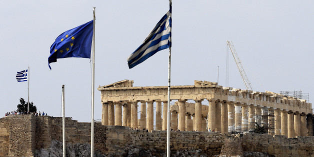 Greek and European Union flags fly on the top of the Finance Ministry in Athens on Tuesday Oct. 9, 2012. German Chancellor Angela Merkel makes her first visit to Greece since the eurozone crisis began three years ago. Her five-hour stop is seen by the government as a historic boost for the country's future in Europe's shared currency, but by protesters as a harbinger of more austerity and hardship. More than 7,000 police will be on hand, cordoning off parks and other sections of central Athens, to keep demonstrators away from the German leader who is due to arrive Tuesday in the Greek capital for talks with conservative Prime Minister Antonis Samaras. (AP Photo/Dimitri Messinis)