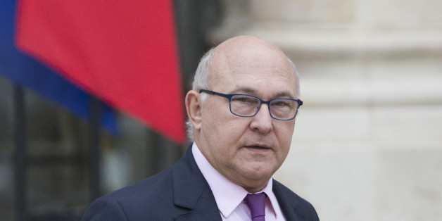 French Finance Minister, Michel Sapin, leaves the Elysee Palace following the weekly cabinet meeting in Paris on Wednesday Dec. 3, 2014. Sapin predicts that spending cuts and higher tax revenue will help lower its budget deficit next year. (AP Photo/Jacques Brinon)