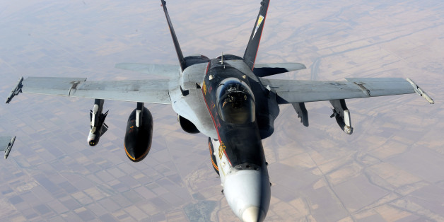 FILE - In this Saturday, Oct. 4, 2014 file photo released by the U.S. Air Force, a U.S. Navy F-18E Super Hornet supporting operations against the militant Islamic State group, leaves after receiving fuel from a KC-135 Stratotanker over Iraq. U.S.-led airstrikes and Iranian aid have helped Iraqi troops, militiamen and Kurdish fighters take back bits around Islamic State-held territory, but recapturing it all remains far out of reach for this country held hostage. (AP Photo/U.S. Air Force, Shawn N