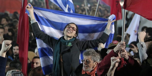 A supporter of Alexis Tsipras leader of Syriza left-wing party holds the Greek flag during a rally outside Athens University Headquarters, Sunday, Jan. 25, 2015. A triumphant Alexis Tsipras told Greeks that his radical left Syriza party's win in Sunday's early general election meant an end to austerity and humiliation and that the country's regular and often fraught debt inspections were a thing of the past. "Today the Greek people have made history. Hope has made history," Tsipras said in his v