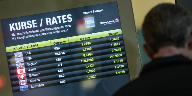 The exchange rate of the US Dollar and the Euro, at top, is displayed in the window of a currency exchange office in Berlin, Monday, Jan. 5, 2015. The euro sank to a nine-year low Monday as new doubts surfaced about Greece's commitment to the common currency bloc. European stocks mostly rose while Asian markets were mixed. (AP Photo/Markus Schreiber)