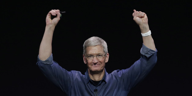Apple CEO Tim Cook introduces Apple Watch , which he is wearing on his wrist, on Tuesday, Sept. 9, 2014, in Cupertino, Calif. (AP Photo/Marcio Jose Sanchez)