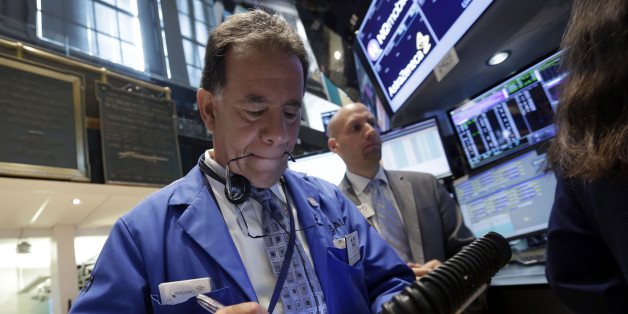 Trader Sal Suarino, left, works on the floor of the New York Stock Exchange Monday, June 2, 2014. U.S. stock futures are creeping higher Monday, ahead of a closely watched manufacturing report. The Standard & Poor's 500 index appears poised to add to its record high reached last week. (AP Photo/Richard Drew)