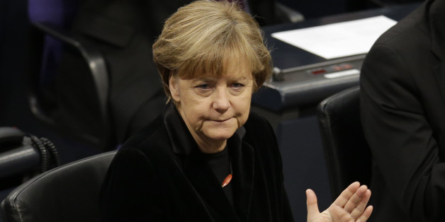 German Chancellor Angela Merkel applauds during a ceremony commemorating the 70th anniversary of the liberation of the Nazi Auschwitz death camp in the German parliament Bundestag in Berlin, Germany, Tuesday, Jan. 27, 2015. (AP Photo/Michael Sohn)