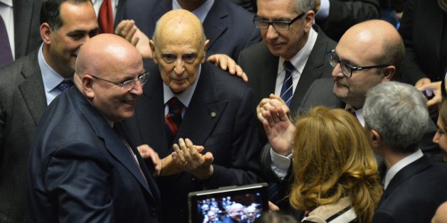 Italy's former President, Giorgio Napolitano (C) surrounded by Italian senators, deputies and representatives of the regions -- members of the electoral college -- applauds newly elected Italian President, Sicilian judge Sergio Mattarella, on January 31, 2015, at the Parliament in Rome. Renzi's backing for Mattarella has been interpreted as the end of a temporary alliance the premier forged with disgraced former prime minister Silvio Berlusconi to help drive labour market and electoral reforms through parliament. Mattarella is seen as an 'anti-Berlusconi' figure, having severed his ties with the centre right in Italian politics partly because of his distaste for the media tycoon, who still heads the opposition Forza Italia party despite a tax fraud conviction. AFP PHOTO / ANDREAS SOLARO (Photo credit should read ANDREAS SOLARO/AFP/Getty Images)