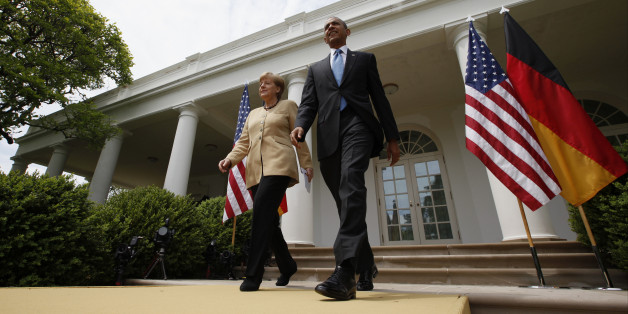 President Barack Obama and German Chancellor Angela Merkel arrive for their joint news conference in the Rose Garden of the White House in Washington, Friday, May 2, 2014. Obama and Merkel are putting on a display of trans-Atlantic unity against an assertive Russia, even as sanctions imposed by Western allies seem to be doing little to change Russian President Vladimir Putin's reasoning on Ukraine. (AP Photo/Charles Dharapak)