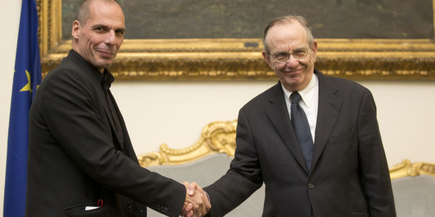 Greece's finance minister, Yanis Varoufakis, left, shakes hands with his Italian counterpart Pier Carlo Padoan during a photo opportunity prior to the start of their meeting in Rome, Tuesday, Feb. 3, 2015. Hopes for a deal between Greece and its European creditors got a boost after the country's new government backed away from demands to write off a chunk of its bailout loans, a prospect that had horrified creditors and investors. Tsipras and Varoufakis arrived in Italy on Tuesday, for talks wit