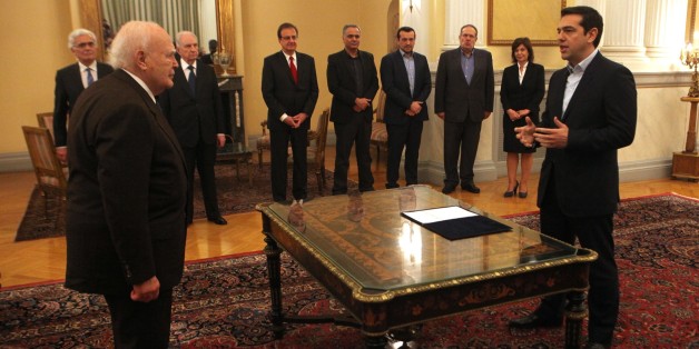 ATHENS, GREECE - JANUARY 26: Syrizas leader Alexis Tsipras (R) swears in by the Greek President Karolos Papoulias (L) during swearing in ceremony after his left-wing Syriza party won Greek parliamentary elections on the day before with just over 35 percent of the votes, official results suggest, at the Presidential Palace in Athens, on January 26, 2015. He has formed an anti-austerity coalition with the right-wing Independent Greek party. (Photo by Ayhan Mehmet/Anadolu Agency/Getty Images)