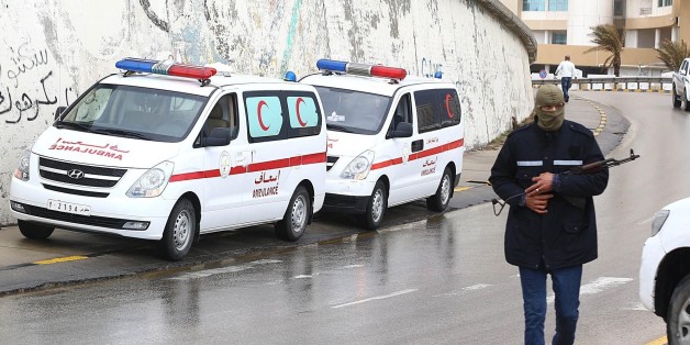 TRIPOLI, LIBYA - JANUARY 27: Libyan security forces and emergency services surround the Corinthia Hotel on January 27, 2015 after a car bomb exploded outside the largest hotel in capital Tripoli on Tuesday. At least two people were allegedly killed and several others injured by the bombing. (Photo by Hazem Turkia/Anadolu Agency/Getty Images)