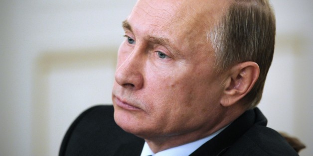 Russian President Vladimir Putin heads a cabinet meeting in the Novo-Ogaryovo residence, outside Moscow, Russia, Wednesday, Feb. 4, 2015. Putin has publicly dressed down his government for allowing a business dispute to scrap commuter trains in provincial Russia. (AP Photo/RIA-Novosti, Mikhail Klimentyev, Presidential Press Service)