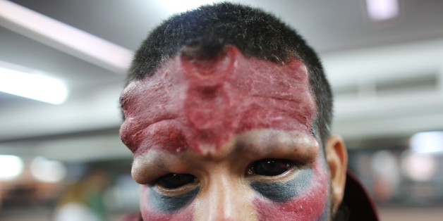 A Venezuelan man known as Red Skull poses for a portrait during the annual Venezuela Tattoo International Expo in Caracas, Venezuela, Thursday, Jan. 29, 2015. Tattoo artists from around the world are gathering for the four-day event that also includes under the skin implants and body piercing. (AP Photo/Ariana Cubillos)