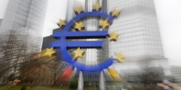 In this zoomed picture the Euro sculpture stands in front of the old European Central Bank in Frankfurt, Germany, Monday, Jan. 26, 2015. The euro wobbled Monday after Greece's anti-austerity opposition party won a big victory in national elections, renewing fears the European common currency bloc could unravel.(AP Photo/Michael Probst)