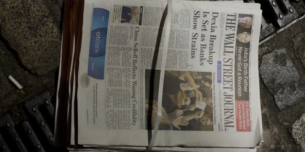 Copies of the European edition of the Wall Street Journal lie on a street in London Wednesday Oct 12 2011. Britain's Guardian newspaper said Wednesday that it had seen emails and documents showing that The Wall Street Journal funneled money through third parties to boost its European circulation, an explosive charge which could be a further blow to Rupert Murdoch's embattled media empire. (AP Photo/ John R Moore)