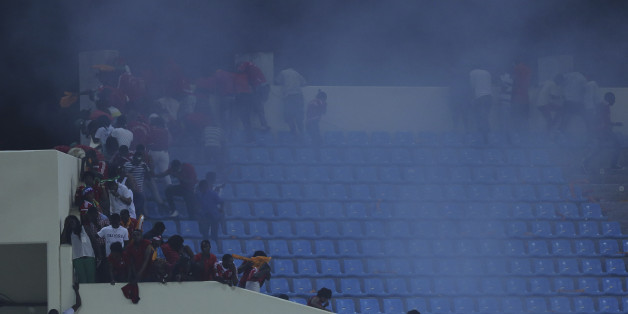 Police use tear gas on Equatorial Guinea supporters after the were throwing objects on the pitch During their African Cup of Nations Semifinals soccer match with Ghana at Estadio De Malabo, Equatorial Guinea, Thursday Feb. 5, 2015. (AP Photo/Sunday Alamba)